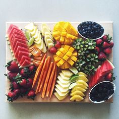 a wooden tray filled with different types of fruit