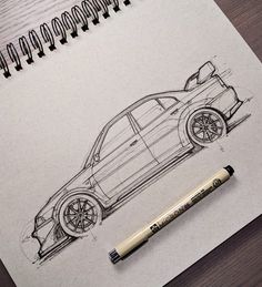 a drawing of a car on top of a piece of paper next to a marker