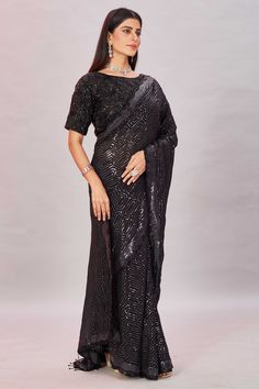 Go for a modern saree look on special occasions in this classy black sequin georgette saree. The saree comes with an embroidered designer blouse. Glamorous Black Fitted Pre-draped Saree, Black Pre-draped Saree With Sequins, Elegant Black Pre-draped Saree With Mirror Work, Festive Black Pre-draped Saree With Self Design, Designer Wear Pre-draped Georgette Saree With Sequins, Embellished Black Pre-draped Saree For Party, Black Pre-draped Saree With Resham Embroidery, Evening Georgette Sequin Fabric With Traditional Drape, Black Embellished Blouse With Traditional Drape