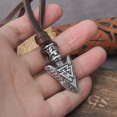 Introducing our Valknut Silver Color Viking Spear Pendant Necklace, a powerful symbol of courage and destiny. Crafted with meticulous detail, this pendant features the iconic Valknut, a revered emblem associated with Norse mythology, intertwined with the classic Viking spear design. Made with high-quality materials, our pendant exudes strength and elegance. Whether you're a devotee of Norse culture, seeking a bold statement piece, or simply drawn to the mystique of Viking symbolism, this necklac Viking Style Nickel Free Necklaces For Gift, Viking Style Nickel Free Necklace For Gift, Viking Style Nickel Free Necklace Gift, Adjustable Viking Style Jewelry Gift, Viking Style Adjustable Necklace As Gift, Nickel Free Viking Necklaces As Gift, Viking Style Adjustable Necklace Gift, Symbolic Brown Pendant Necklace, Symbolic Brown Pendant Jewelry