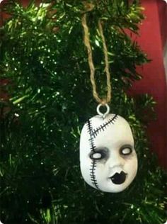 an ornament hanging from a christmas tree decorated with white and black face paint