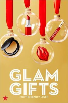 glam gifts for the beauty lover are hanging from red ribbon and glass ornaments with lipstick on them