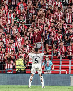 the soccer player is celebrating his team's victory over the crowd in front of him