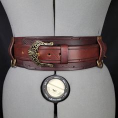 Choose Brown/ or black 3" Inch Leather belt for Viking, Cosplay or Larp costuming.  Hang sword or ax frogs, mug, pouch or skirt rings. 4 D rings are available with a belt. (accessories not included) The top belt can be worn separately from its 3" backing. This is a standard version of this belt. A "Deluxe" model is available in another listing. Hand tooled and stamped 8 OZ leather. Dyed, Rivets, Rings, and Celtic Buckle. Made to order 1-2 week delivery. Medieval Corset Belt For Festivals, Medieval Style Corset Belt For Festivals, Medieval Corset Belt For Larp With Belt Loops, Gothic Adjustable Corset Belt With Belt Included, Adjustable Gothic Corset Belt With Included Belt, Gothic Leather Corset Belt, Steampunk Leather Corset Belt For Cosplay, Gothic Leather Corset Belt For Larp, Medieval Brown Corset Belt For Larp