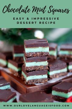 chocolate mint squares are stacked on top of each other in front of a christmas tree