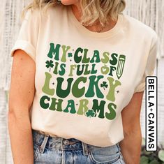 "St Patrick's Day Teacher Shirt, My Class Is Full Of Lucky Charms, Cute Teacher Gift, Teacher Appreciation Tee, Teacher Life, New Teacher Tee Welcome to LunaTeeApparel ☺️ Our shirts are clean, high quality and soft. It is prepared quickly by our boutique Ironing and shipped. Enjoy your shopping It is a pleasure for us to help you with your questions and you can reach us at any time. Please, don't forget to check our size cards. HOW TO ORDER SHIRT 👕 Please, choose your favorite t-shirt color and size from the pop-up window. Select the quantity that you want. Click \"ADD TO CART\" You can go back to add more product color for your loved ones members. You can complete the checkout process Please \"Click Proceed to Check Out\" Finally, you have completed all the steps, your product will be pr St Patricks Day Shirts For Teachers, St Patrick’s Day Teacher Shirts, Green Graphic Tee With Lettering, Green Cotton T-shirt With Lettering, Childcare Teacher, Cute Teacher Gifts, Teacher Wardrobe, Lunch Lady, Text Shirt