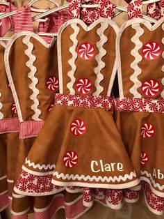 several gingerbread oven mitts with candy canes on them and personalized name