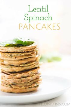 a stack of pancakes with spinach leaves on top and the words lentil spinach pancakes