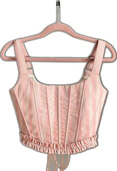 Pink Feminine Corset With Boned Bodice, Feminine Pink Underbust Corset, Pink Underbust Feminine Corset, Pink Feminine Underbust Corset, Pink Ruffled Corset For Spring, Spring Pink Ruffled Corset, Spring Pink Corset With Ruffles, Pink Sleeveless Fitted Corset, Pink Sleeveless Corset With Fitted Bodice