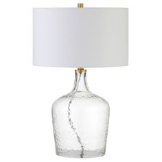 a glass table lamp with a white shade