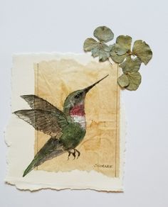 a hummingbird with green leaves on it's back