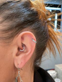 a close up of a person with ear piercings on their ears and behind the ear