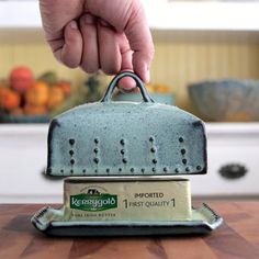 a person holding a grater on top of a wooden table