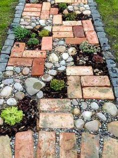 a garden path made out of bricks and stones