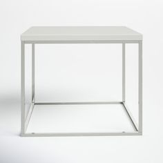 a white square table with metal frame on the bottom and one shelf below it, against a white background