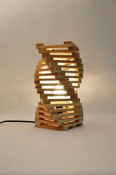 a lamp made out of wooden planks on a table