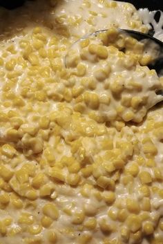 a pot filled with cooked corn on top of a stove