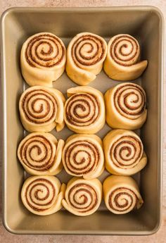 cinnamon rolls in a baking pan ready to go into the oven for making cupcakes