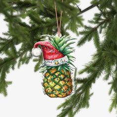 a christmas ornament hanging from a pineapple tree with a santa hat on it