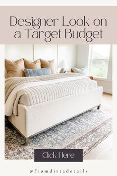 a white bed sitting in the middle of a bedroom next to a rug and window