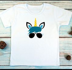 a t - shirt with an image of a unicorn wearing sunglasses