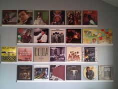 the wall is filled with many different album covers