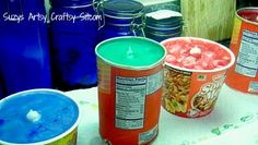 three buckets of food sitting on top of a table next to blue containers with lids