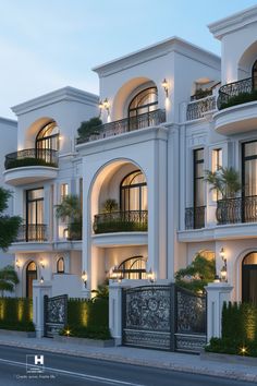 a large white building with balconies on the second floor and balconyes at night