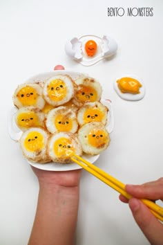 someone is holding a plate with eggs and some chopsticks