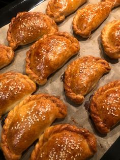 baked pastries are lined up on a baking sheet