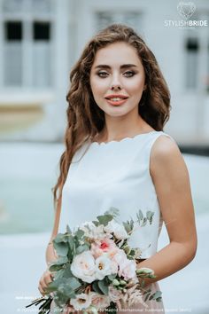 a beautiful woman holding a bouquet of flowers