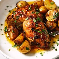 a white plate topped with chicken and potatoes