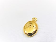 Vermeil, 18k gold plated over 925 sterling silver love charm. measures about 11x7mm including loop. 1 pc. shiny vermeil for the larger quantity convo us. thanks for stopping by. Gold Heart Charm Pendant, Gold Pendant Charms With Dainty Style, Dainty Gold Pendant Charms, Gold Dainty Pendant Charms, Dainty Gold Round Pendant Charms, Tiny Gold-plated Charm Necklaces, Tiny Gold Plated Charm Necklaces, Gold Vintage Charm Heart Pendant, Gold Heart Pendant Vintage Charm