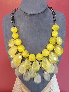 This vintage necklace is a stunning addition to any jewelry collection. The beaded bib design features beautiful shades of yellow with a stunning 17-20-inch length that is sure to make a statement. Crafted from durable Lucite material, this necklace is both stylish and practical. The beads are expertly crafted to create a unique and eye-catching design that will turn heads wherever you go. Perfect for any occasion, this necklace is a must-have for any fashion-forward individual looking to add a Luxury Yellow Round Beaded Necklaces, Party Jewelry With Large Yellow Beads, Vintage Yellow Necklace With Colorful Beads, Yellow Necklaces With Faceted Beads, Elegant Yellow Necklaces With Large Beads, Yellow Necklace With Faceted Beads, Elegant Yellow Necklace With Large Beads, Yellow Beaded Costume Jewelry Necklace, Yellow Beaded Bib Necklaces With Round Beads