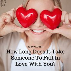 a woman holding two red hearts over her eyes with the words how long does it take someone to fall in love with you?