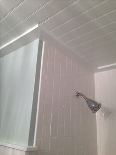 the shower head is on the wall in the bathroom