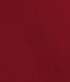 a red fabric background with white stitching