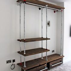 the shelves are made from metal pipes and wood