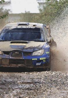 a subarun car is driving through the mud