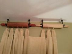 the curtain rod is hanging from the ceiling