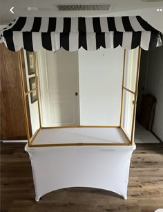 a black and white canopy bed with gold trim