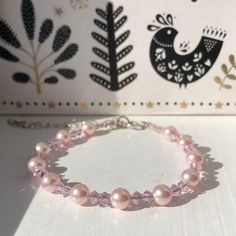 This is an adjustable beaded bracelet made with pink pearl beads (6mm), interspersed with pink crystal bicone beads (3mm). It measures approximately 18cm including the clasps, and has a silver tone extension chain. 2 are available. The bracelet is made with wire and is not stretchy. It is designed to drape over a 17cm wrist or fit a larger wrist size using the extension chain. Care instructions: It's best to keep these bracelets away from water and harsh chemicals, and to be careful to put them Princess Bracelet, Pink Pearl Bracelet, Semi Precious Jewelry, Bracelet Crystal, Pink Beads, Pink Pearl, Pink Crystal, Gift Birthday, Pearl Bracelet