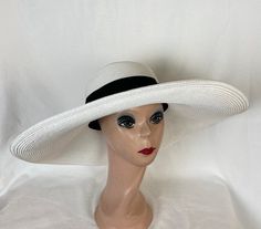 This white Toyo straw 6-inch brim sun hat has a flat brim and black ribbon band.  The hat is great for any event and packable with excellent UV protection. The hat comes in medium and large head sizes and has an inside sizing cord to adjust to your head size. The medium fits 22 - 22.5 inch head size. The large will fit 59cm 22.5- 23 1/4-inch head size NOTE: Please check the head size before purchase, I am happy to answer any questions you may have. There will be a 20% restocking fee for all retu White Fitted Hat Bands For The Beach, White Fitted Hat Band For Beach, Fitted White Panama Hat For Beach, White Fitted Panama Hat For Beach, Adjustable White Boater Hat With Curved Brim, White Adjustable Boater Hat With Curved Brim, Adjustable White Boater Hat, Fitted White Fedora Sun Hat, White Fitted Fedora Sun Hat