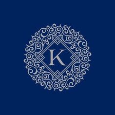 the letter k in a circle with swirls around it on a dark blue background