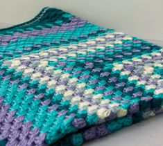 a crocheted blanket sitting on top of a table