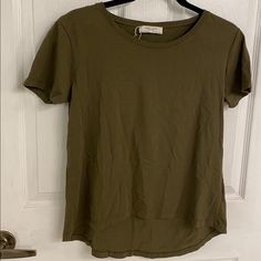 Zara Organic Cotton W&B Tee Khaki Green Color Round Scoop Neck Short Sleeves High Low Hem Tag Pulled Off, But This Is Brand New! Other Than Some Wrinkles This Is In Perfect Condition Size Small Basic Khaki Short Sleeve Tops, Trendy Khaki Short Sleeve T-shirt, Everyday Green Scoop Neck T-shirt, Basic Short Sleeve Top With Shirttail Hem For Spring, Summer Khaki Crew Neck Tops, Khaki Stretch Crew Neck Top, Khaki Short Sleeve T-shirt For Spring, Khaki Crew Neck T-shirt, Spring Khaki Crew Neck Top