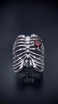 🩻 Ribcage Ring ❤️ Features a red heart shaped cubic zirconia stone ⛓ 100% solid 316L stainless steel 💦 Waterproof 👽 NO green skin. NO tarnish. NO rust 🖐 Sizes 5-11 available Rib Cage Ring, Goth Rings Aesthetic, Alt Rings, Emo Rings, Strange Rings, Goth Rings, Goth Ring, Red Ring, Edgy Jewelry