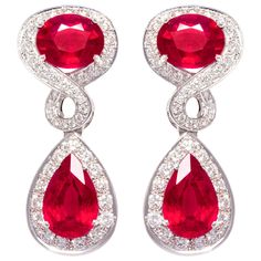 The ruby and diamond earrings feature 4 faceted African rubies of homogeneous brilliance for a total of 21.50 carats. The elegant design is complete with 2.70 carats of round diamonds of top quality (F-G/VVS). The earrings are flexible just to the right extent. They were entirely hand made in 18 carat gold by maestro Scalabri in our own workshop in Italy according to an original design by Ella Gafter. They are signed EG. Ruby And Diamond Earrings, White Gold Drop Earrings, Ruby Jewellery, Fantasy Earrings, Vintage Drop Earrings, Bling Earrings, Sparkly Jewelry, Jeweled Earrings, Earrings Design