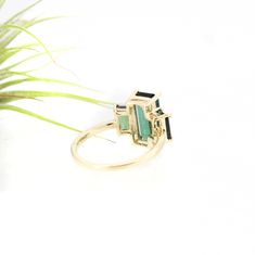 The showstopper. Three lush luxurious AA green tourmalines are set in slim claw settings and sit atop a classic round band. Classic with a twist, this art deco inspired piece makes a fantastic statement ring or a wedding piece. Metaphysically, green tourmaline carries the essence of the earth and her plant kingdom. It's conducive to healing, happiness, and setting a clear & grounded direction for the future. 3.79 ctw AA green tourmaline and solid 14k yellow gold. US size 7 but can be resized Elegant Emerald Cut Tourmaline Jewelry, Elegant Emerald Cut Tourmaline Ring, Elegant Emerald-cut Tourmaline Ring, Baguette Cut Tourmaline Jewelry For Weddings, Elegant Tourmaline Rings With Accent Stones, Elegant Tourmaline Sapphire Ring For Wedding, Elegant Tourmaline Sapphire Wedding Ring, Art Deco Green Emerald Multi-stone Ring, Elegant Tourmaline Wedding Ring