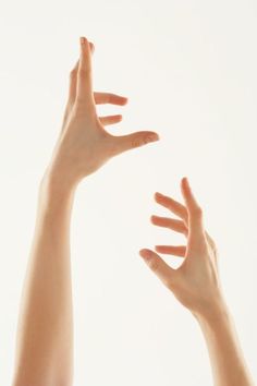 two hands reaching up into the air